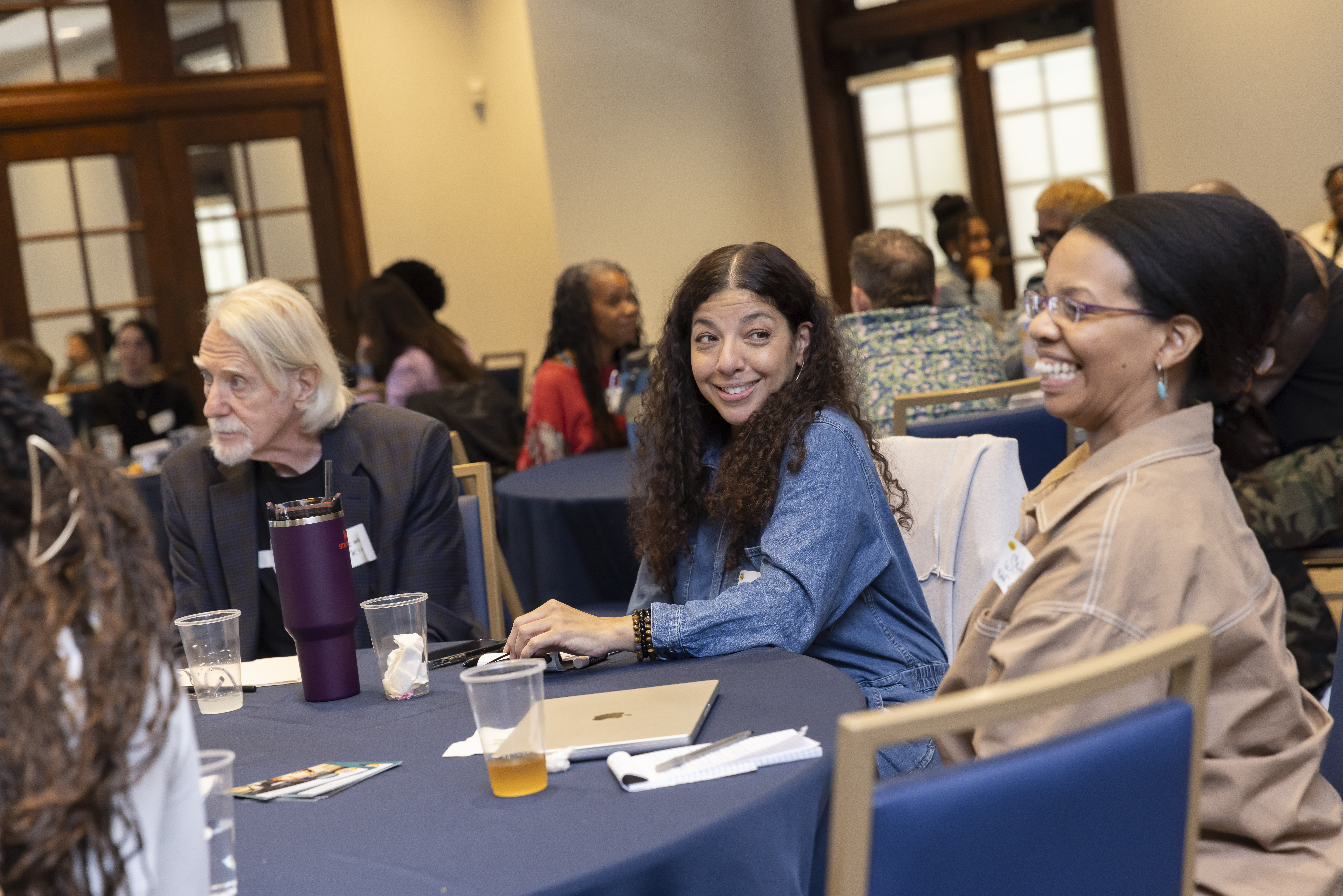Participants at docethics workshop at a round table laughing