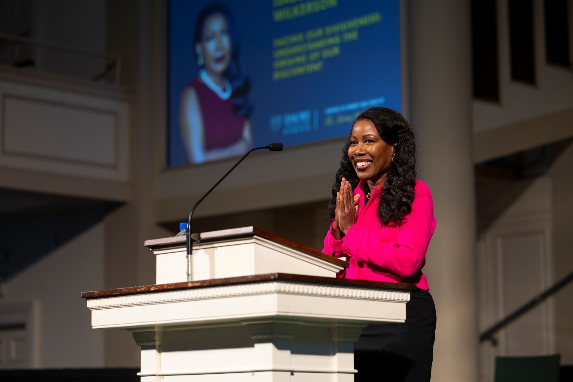 Author Isabel Wilkerson thanking an audience with her hands clasped together